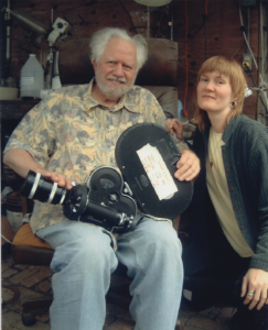 Sasha Shulgin sitting with movie camera on his lap with Connie Littlefield beside him.