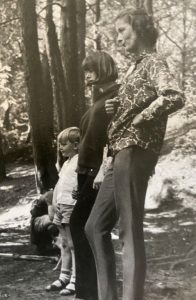 Julian, Helen, and Jane Osmond standing in a forest.