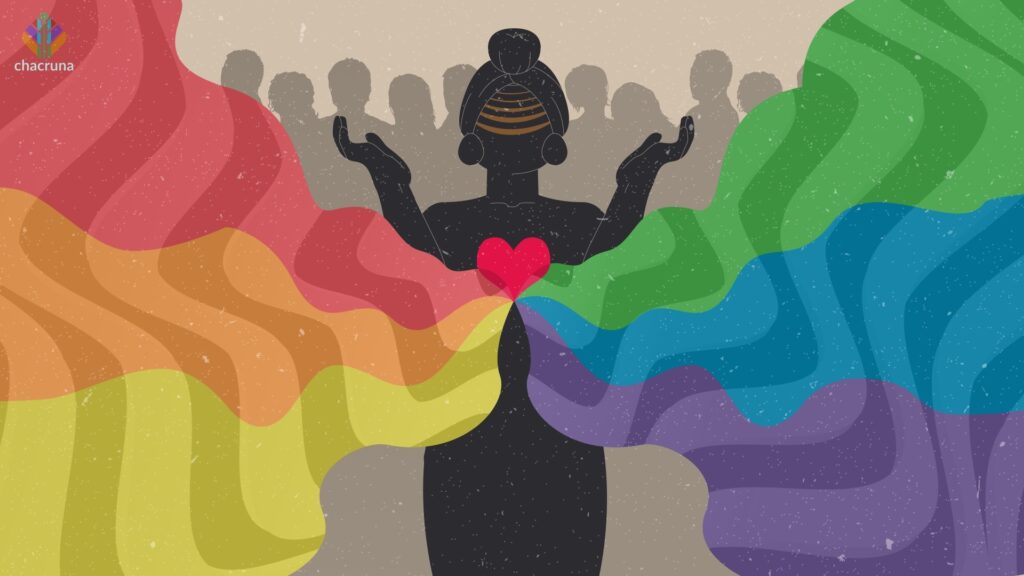 A black silhouette of a person with a red heart with rainbow colours emanating from it. Other silhouettes of people stand behind the first figure. 