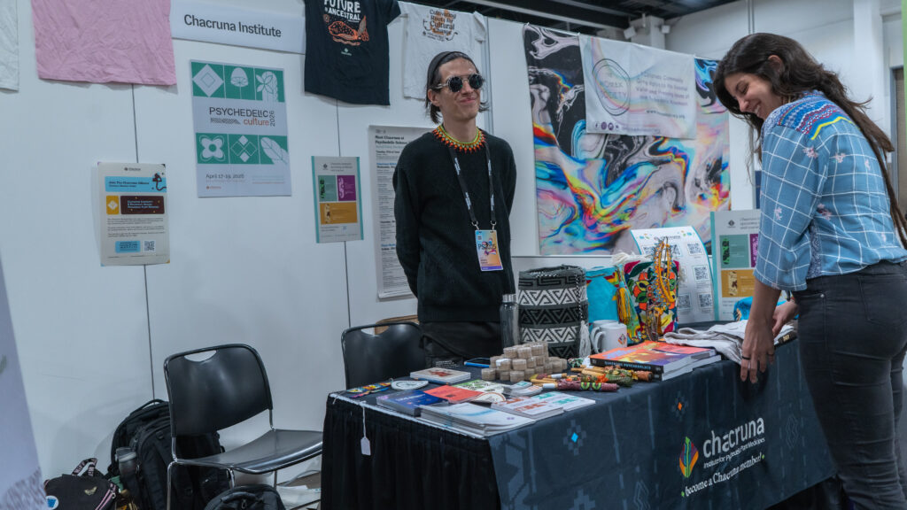 Ibrahim Gabriell and Paula Bizzi Junqueira at the Chacruna table at Psychedelic Science 2025. 